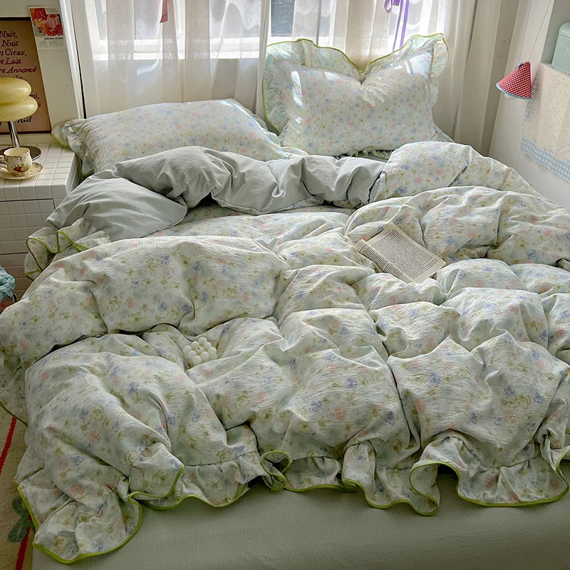 A floral duvet cover set featuring light green and white patterned fabric with matching pillowcases and a flat sheet displaye