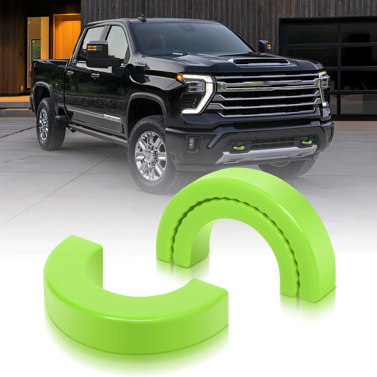 A black pickup truck is shown with bright lime green silicone tow hook covers displayed next to it.