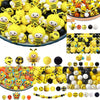 A collection of yellow and black silicone beads shaped like bees for jewelry making and DIY crafts.