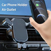 A black silicone car phone holder is attached to a car air outlet, holding a smartphone.