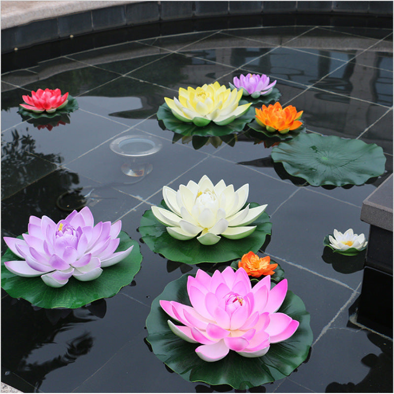 A collection of vibrant pink, yellow, and purple lotus flowers floating on dark water in a pond or garden.