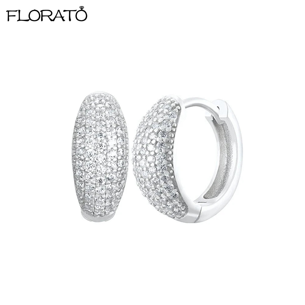 A pair of silver-toned minimalist CZ huggie hoop earrings with a pave diamond finish.