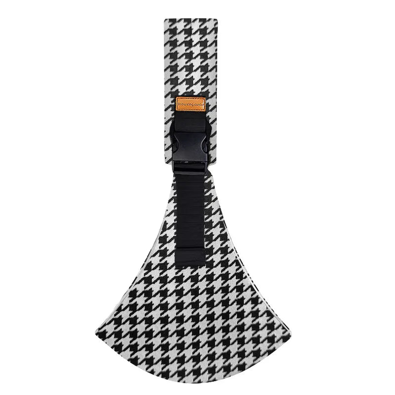 Black and white patterned ergonomic baby sling carrier with a black strap and padded hip seat