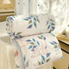 White comforter with a panda print featuring pink rabbits and green leaves, displayed near a window.