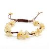 A braided bracelet made of natural crystal chips and stones with a brown macrame cord.