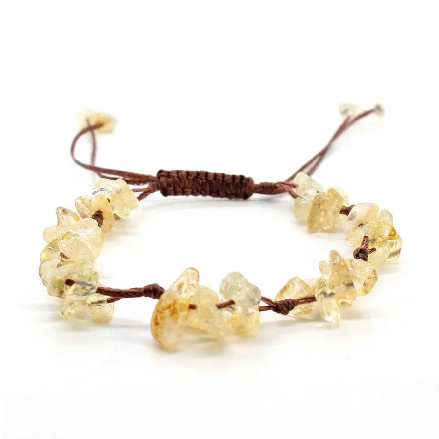 A braided bracelet made of natural crystal chips and stones with a brown macrame cord.