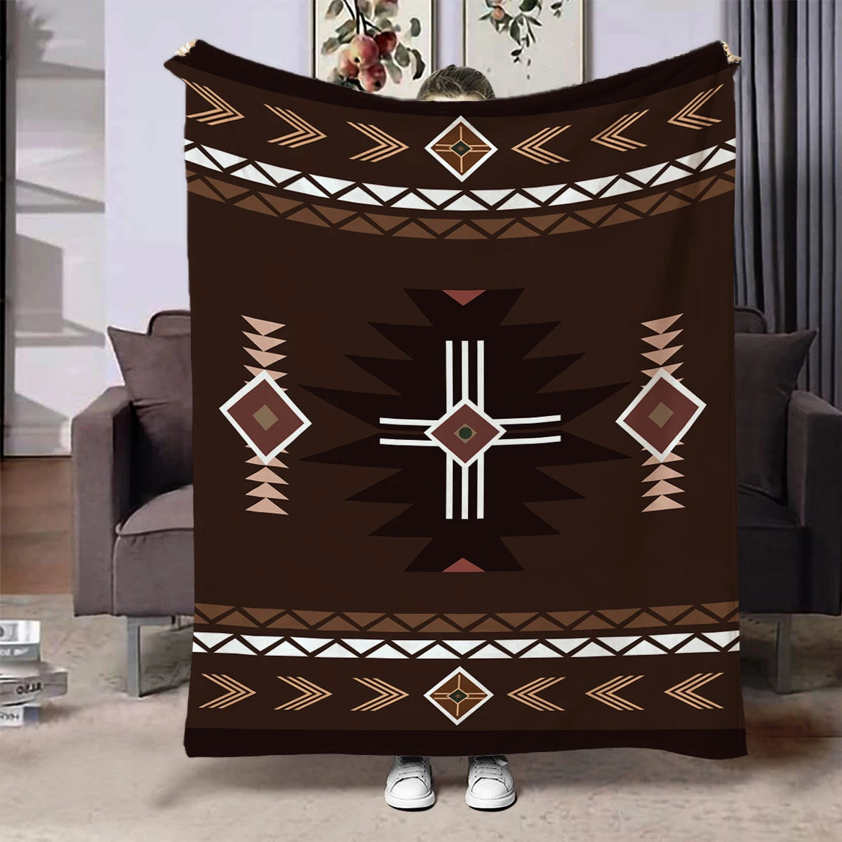 A dark brown flannel throw blanket featuring geometric ethnic patterns in white and tan.