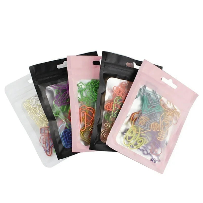 A collection of colorful decorative bookmarks with paper clips in various colored pouches.