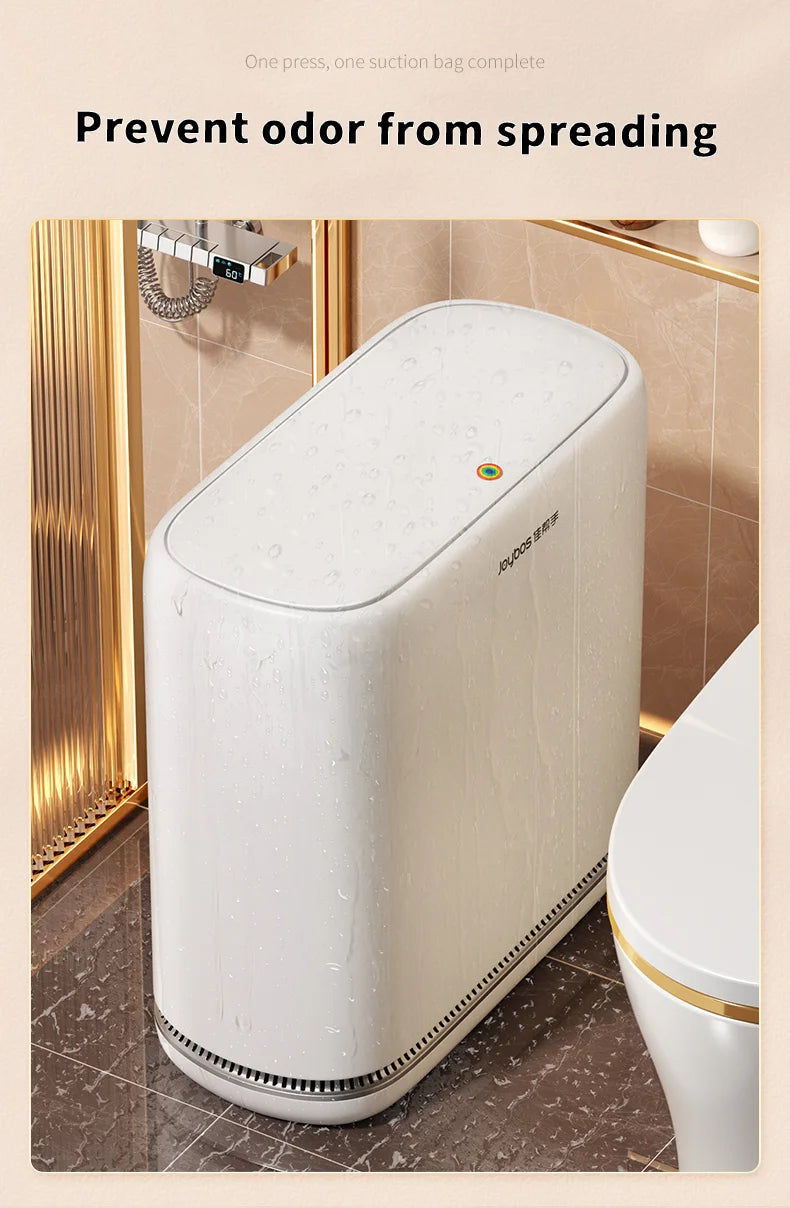 A white touchless trash can with an auto bagging feature is shown in a bathroom setting.