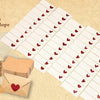 A set of blank note cards and envelopes with red hearts, arranged on a light beige background.