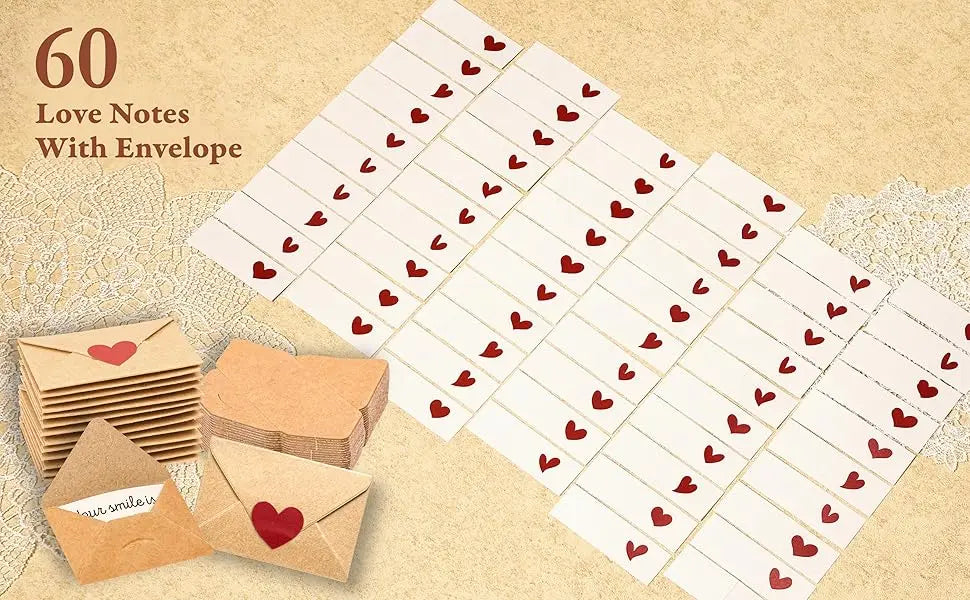 A set of blank note cards and envelopes with red hearts, arranged on a light beige background.