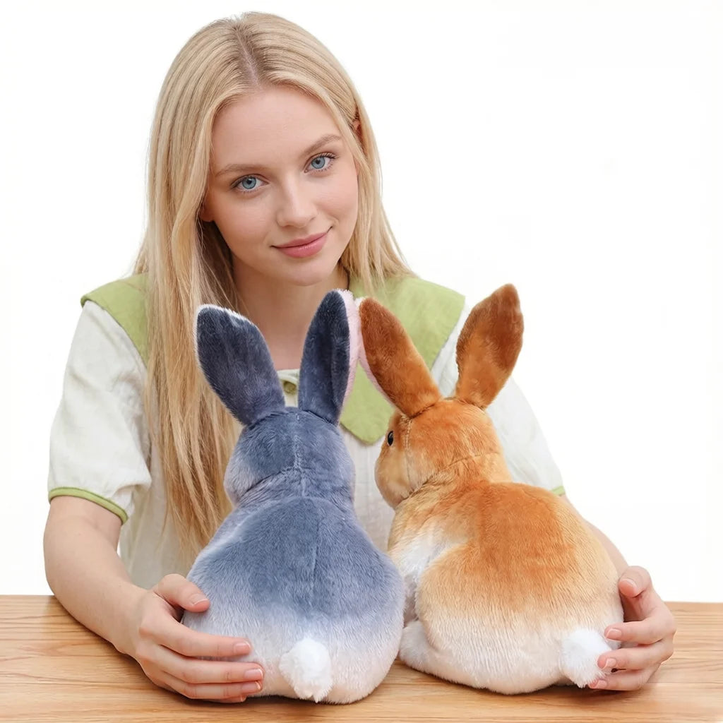 A young woman holds a gray and white plush rabbit stuffed animal.