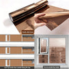 Double-sided brown frosted privacy window film shown being rolled and applied to a window pane.