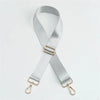 Silver nylon bag strap with a gold buckle shown diagonally against a white background.