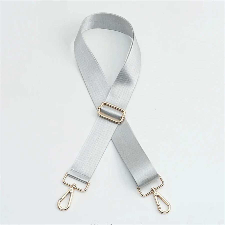 Silver nylon bag strap with a gold buckle shown diagonally against a white background.