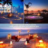 A set of solar torch lights illuminating a beach scene with warm glow on sand and water.