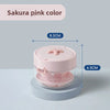 A pink portable retainer and denture cleaning case with an effervescent tablet dispenser shown from above.