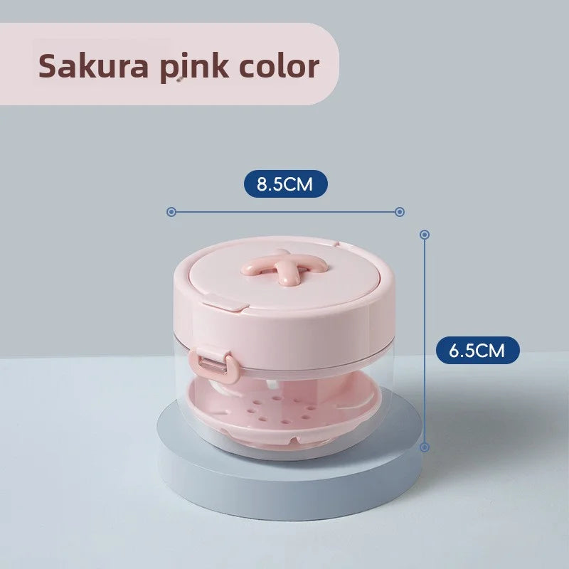 A pink portable retainer and denture cleaning case with an effervescent tablet dispenser shown from above.