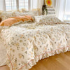 A floral ruffle cotton duvet cover set featuring a light cream background with soft yellow and blue floral patterns.