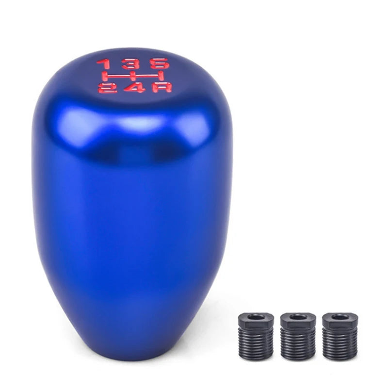 A blue aluminum gear shift knob with red markings and three separate adapters.