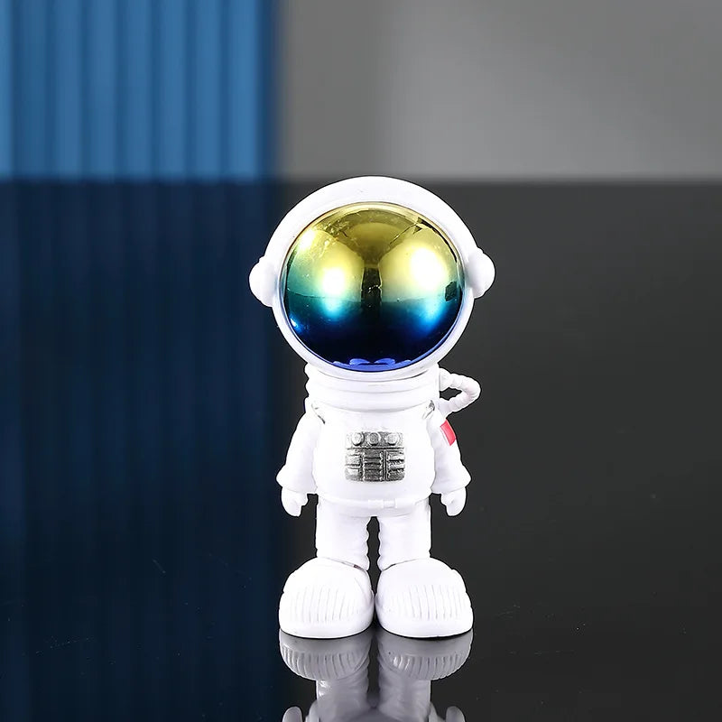 A white astronaut figurine with a reflective visor and suit details, displayed on a dark surface.