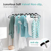 A display of luxurious soft velvet non-slip hangers with anti-slip notches on a white clothing rack.