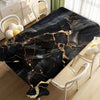 Black gold marble waterproof tablecloth displayed on a table with white chairs.
