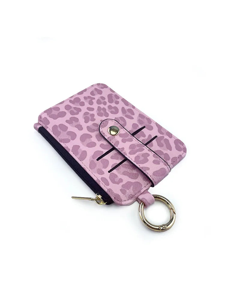 A purple leopard print PU leather card holder with a coin pocket and keychain.