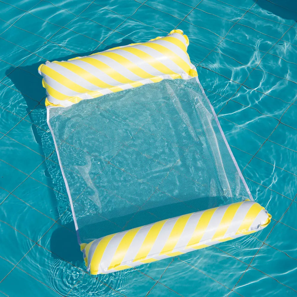 A yellow and white striped inflatable lounge chair with a clear net backrest floating in blue water.