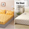 A fitted sheet and flat sheet bedding set in yellow and white polka dots with a matching duvet cover and pillows.