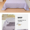A stack of purple quilted polyester coverlets with floral embroidery displayed on a white background.