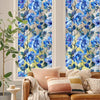 A close-up of a floral stained glass window film featuring blue and green flowers on a light background.