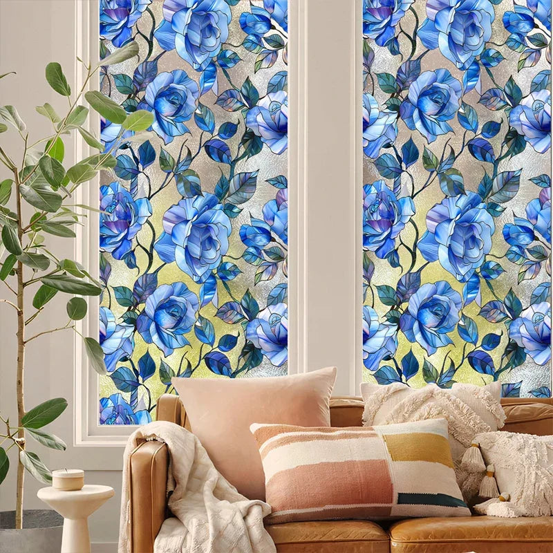 A close-up of a floral stained glass window film featuring blue and green flowers on a light background.