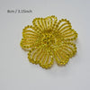 A bright yellow crystal rhinestone flower patch with a textured, petal-like design.