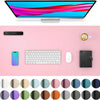 A pink desk pad featuring a computer monitor, keyboard, mouse, and various colored circles.