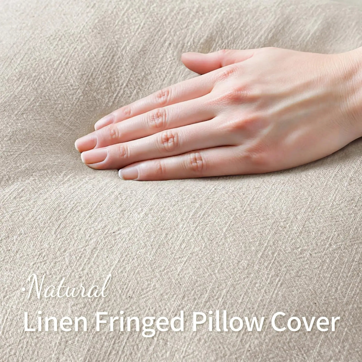A hand gently touches a natural linen fringed pillow cover with a soft, neutral beige texture.