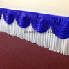 Elegant ice silk table skirt in royal blue and white with matching top swag displayed on a table.