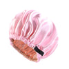 Pink satin sleep bonnet with elasticized edge and a black tie