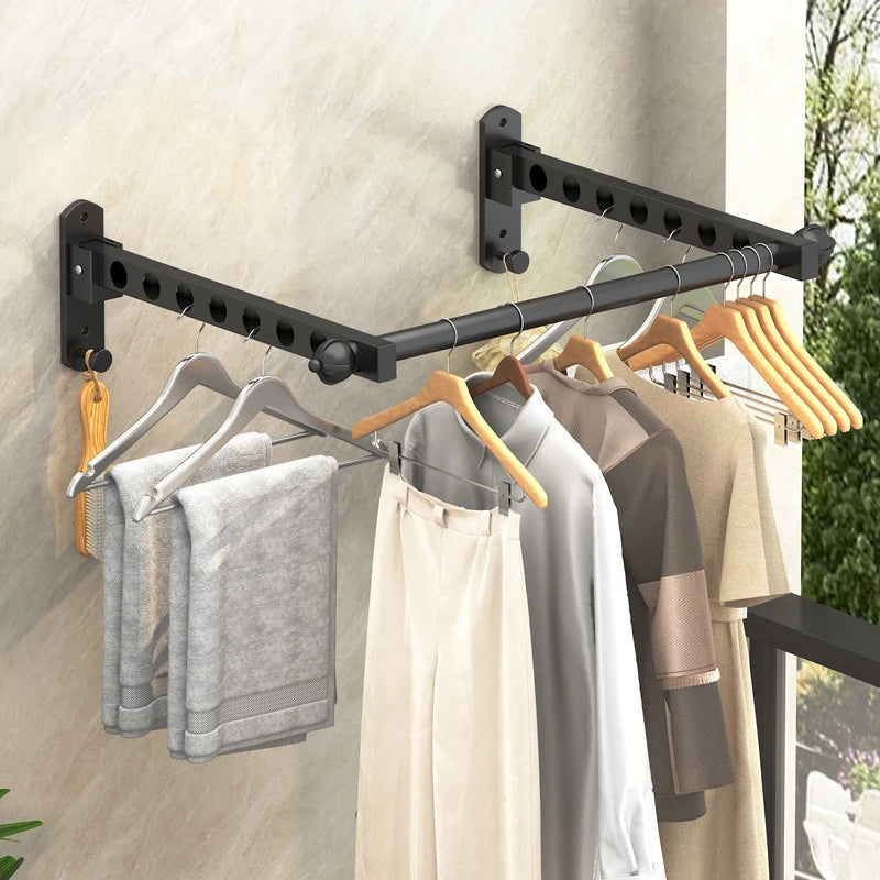 Black foldable wall-mounted clothes drying rack with wooden hangers displaying various garments.