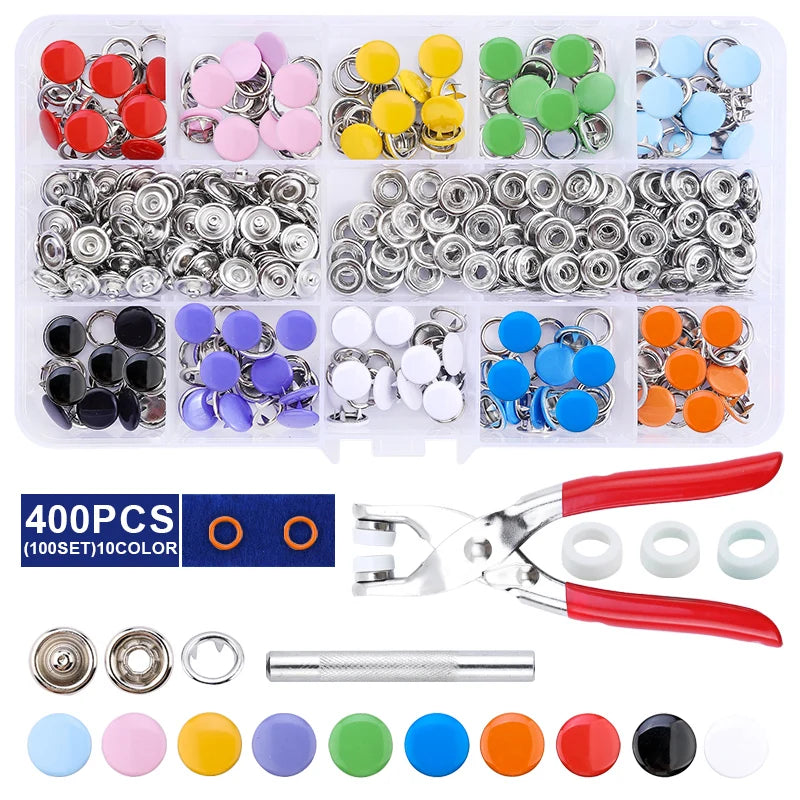 A collection of metal snap fasteners, various colors, and a pair of pliers tool.