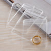 A stack of transparent PVC jewelry pouches with zip lock closures, featuring a gold ring.