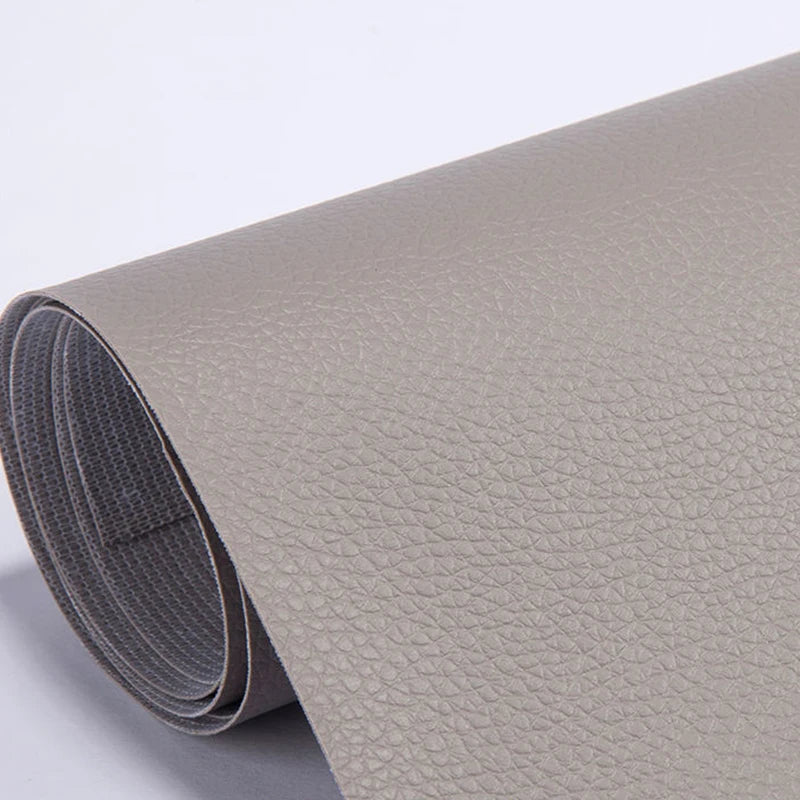 Roll of beige self-adhesive PU leather repair patches, showing the texture and roll form.