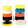 A set of yellow, white, orange, and black self-adhesive polishing pads for car detailing.