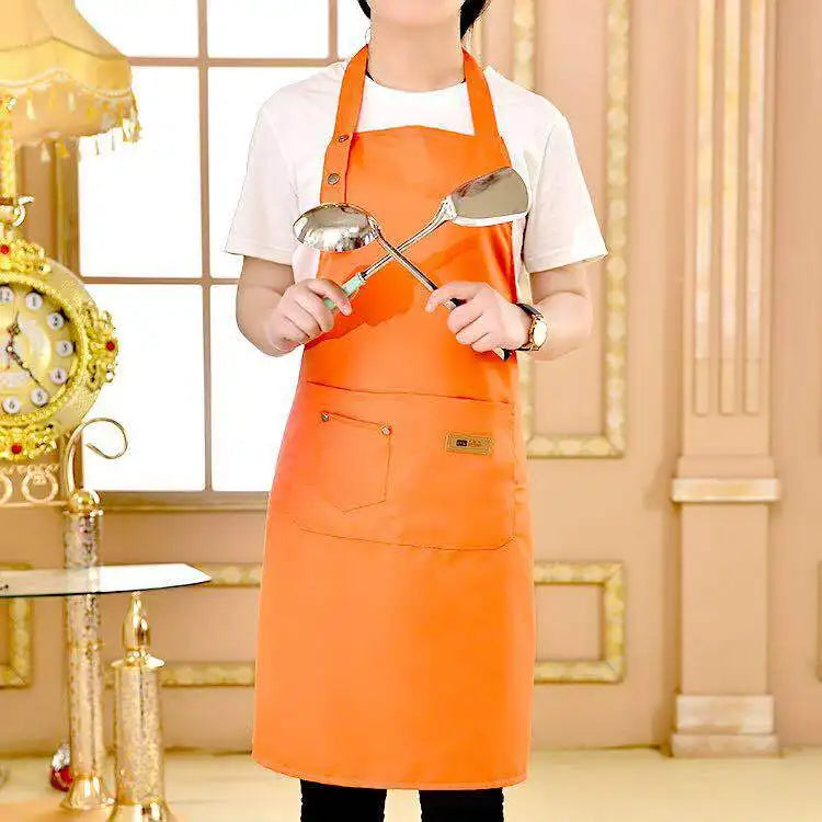 A woman wearing an orange cotton apron standing in a brightly lit room.