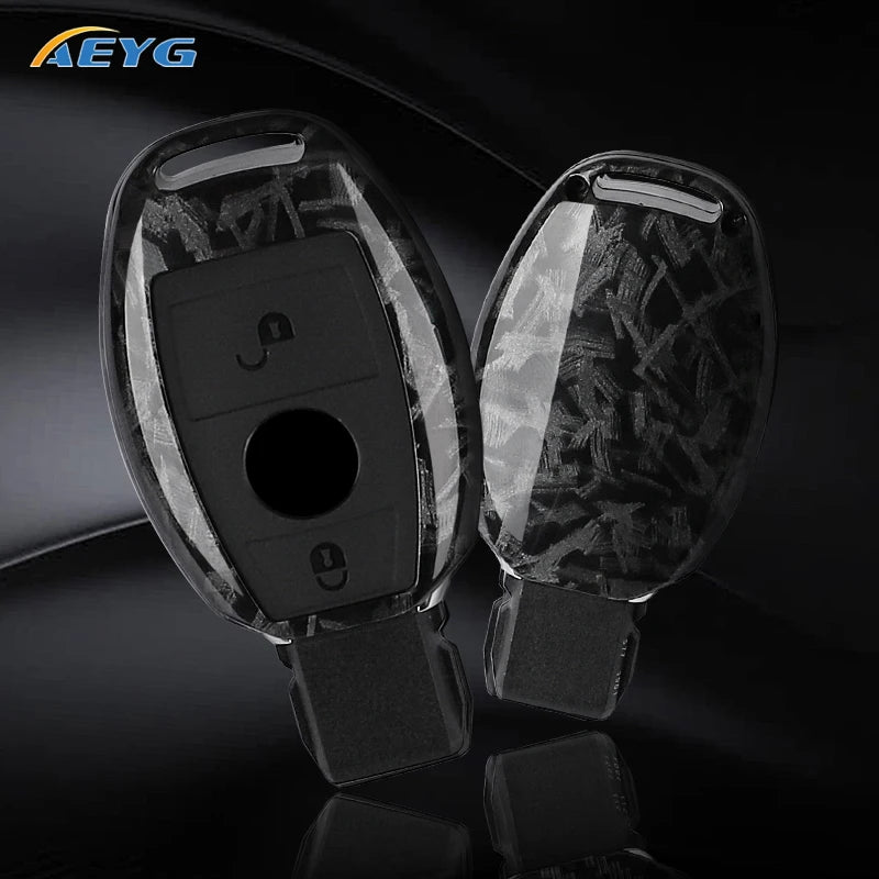A clear silicone car key cover with a black carbon fiber design and a built-in key slot.