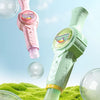 A pink and green smoke bubble tour device is shown with various bubbles on a green grassy surface.
