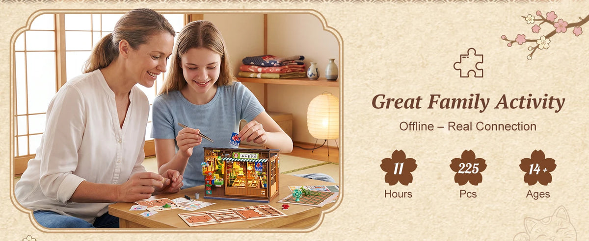 Two women assembling a vintage Japanese corner shop DIY book nook kit with an LED light for a great family activity.