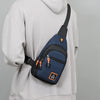 A navy blue water-resistant crossbody bag with an orange strap is shown attached to a light gray hoodie.