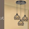 A chandelier featuring multiple crystal glass bulbs suspended from a modern metal ceiling mount.