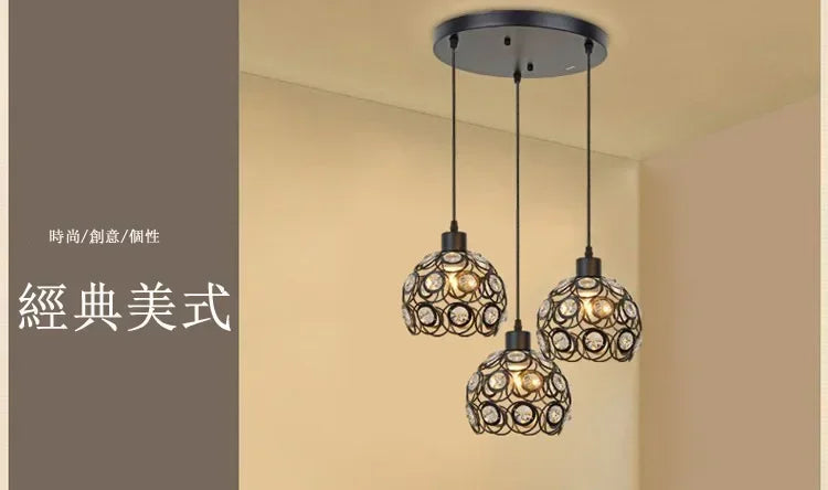 A chandelier featuring multiple crystal glass bulbs suspended from a modern metal ceiling mount.